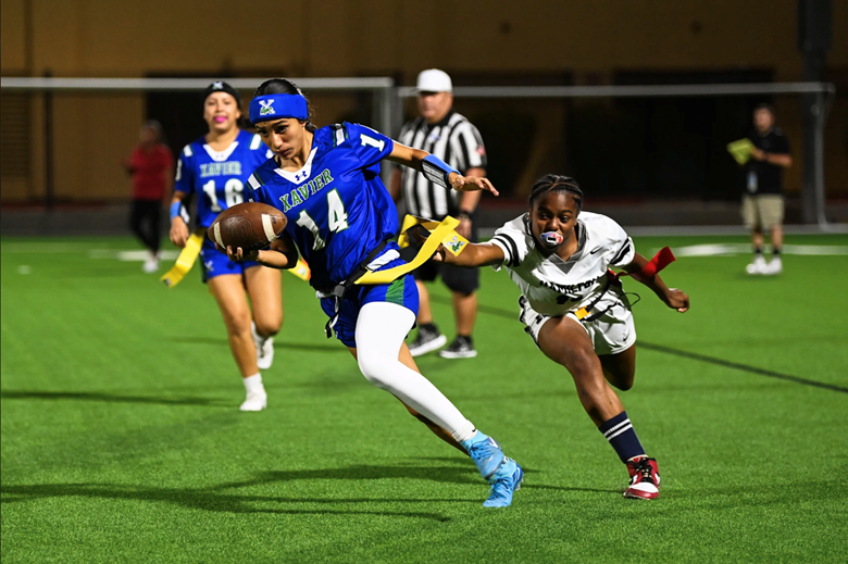 A group of people playing football on a field.