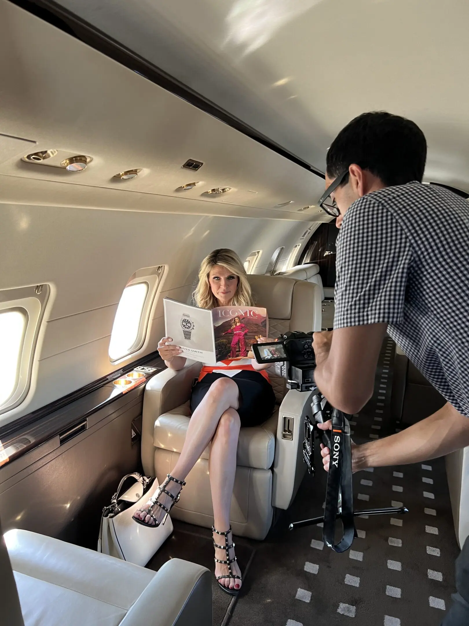 Branded Iconic Bts airplane A man and woman sitting on the back of an airplane.