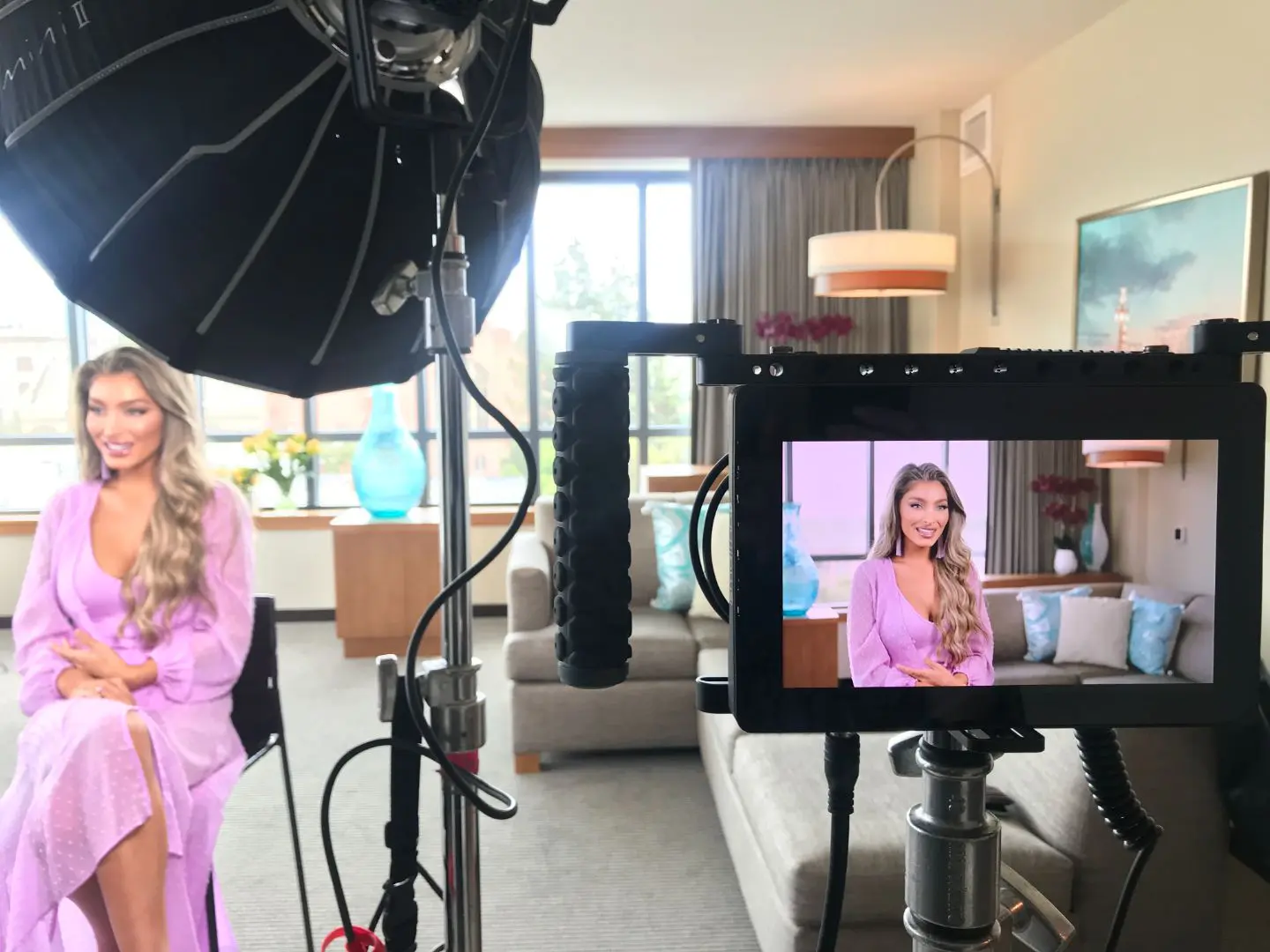 A woman in pink is filming her photo.